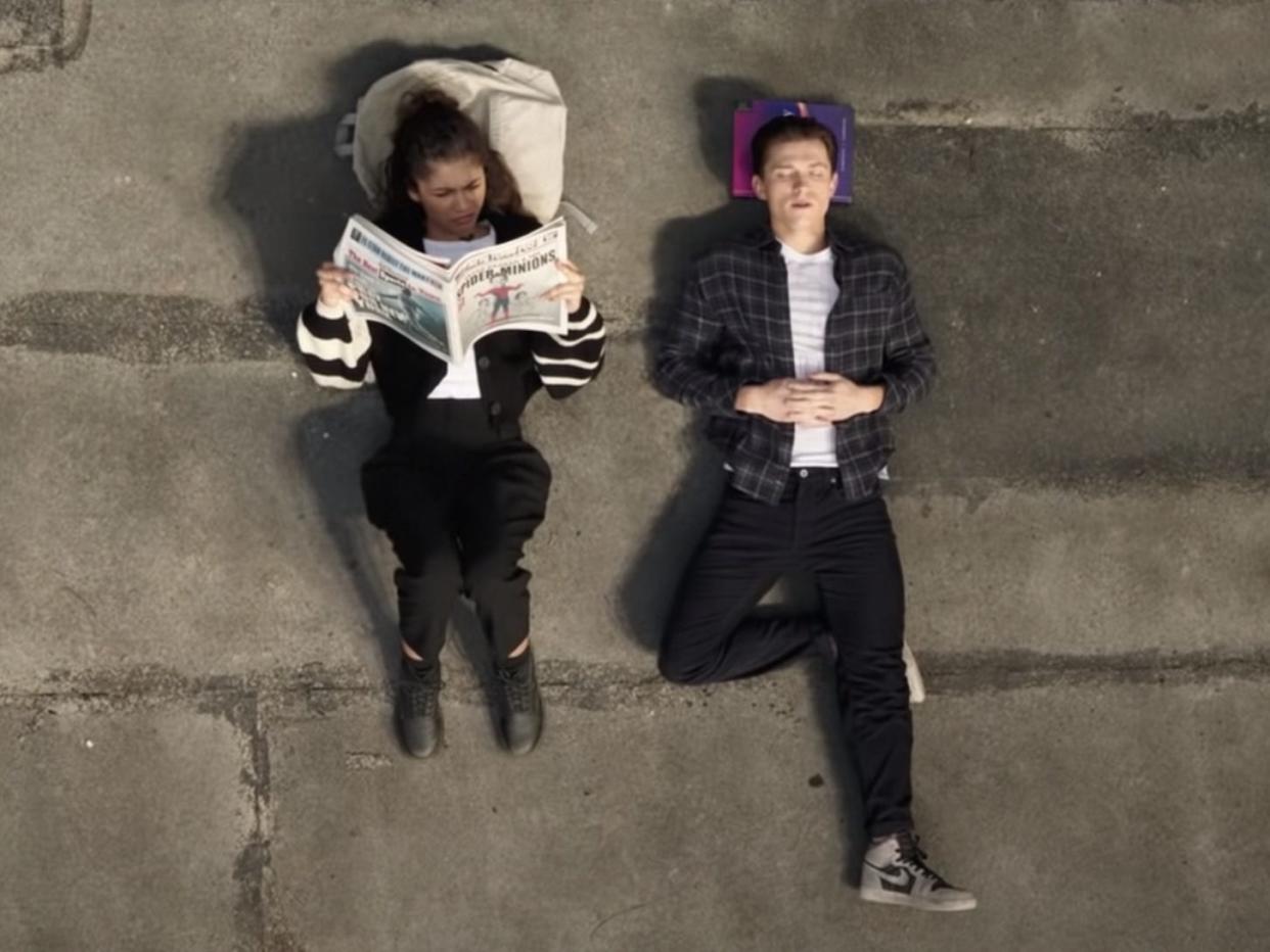 Zendaya and Tom Holland lying on a rooftop in "Spider-Man: No Way Home."