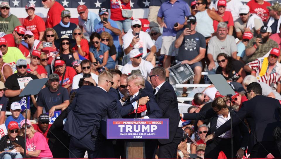 Republican presidential candidate and former U.S. President Donald Trump is assisted by U.S. Secret Service personnel after he was shot in the right ear during a campaign rally at the Butler Farm Show in Butler, Pennsylvania, U.S., July 13, 2024.