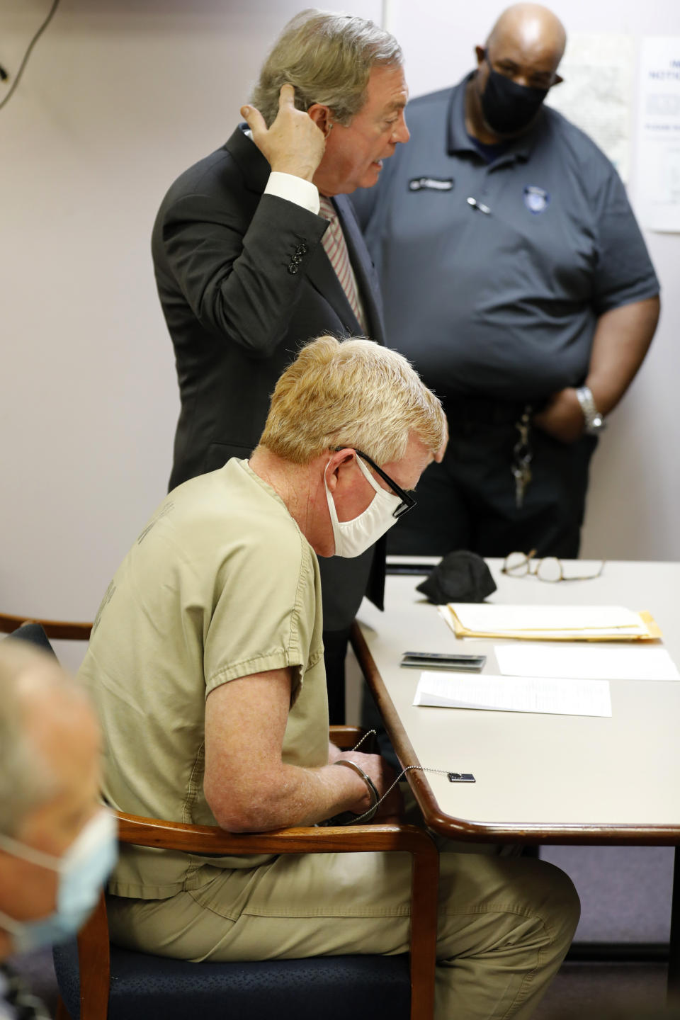 Alex Murdaugh's attorney Dick Harpootlian points to his head where Murdaugh, center, was shot in the head during Murdaugh's bond hearing, Thursday, Sept. 16, 2021, in Varnville, S.C. Murdaugh surrendered Thursday to face insurance fraud and other charges after state police said he arranged to have himself shot in the head so that his son would get a $10 million life insurance payout. (AP Photo/Mic Smith)