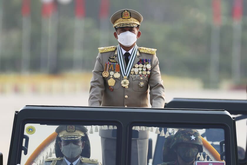 Senior Gen. Min Aung Hlaing, head of the military council, inspects officers during a parade to commemorate Myanmar's 77th Armed Forces Day in Naypyitaw, Myanmar, Sunday, March 27, 2022. The occasion commemorates resistance against Japanese occupiers during World War II, and is a show of strength as the military battles armed resistance to its takeover last year that ousted the elected government of Aung San Suu Kyi. (AP Photo/Aung Shine Oo)