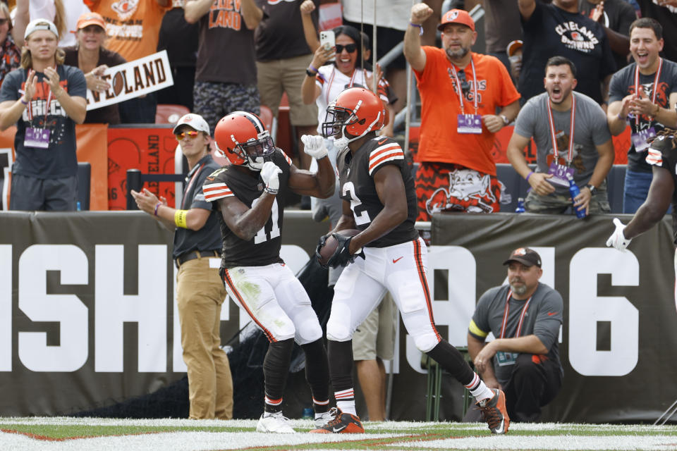 Cleveland Browns wide receivers Amari Cooper (2) and Donovan Peoples-Jones (11) celebrate after Cooper caught a touchdown pass against the New York Jets during the first half of an NFL football game, Sunday, Sept. 18, 2022, in Cleveland. (AP Photo/Ron Schwane)