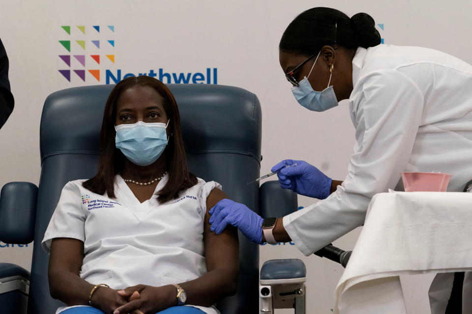 Sandra Lindsay,  a nurse at Long Island Jewish Medical Center, is inoculated with the coronavirus disease (COVID-19) vaccine by Dr. Michelle Chester from Northwell Health at Long Island Jewish Medical Center in New Hyde Park, New York, U.S., December 14, 2020.  Mark Lennihan/Pool via REUTERS     TPX IMAGES OF THE DAY