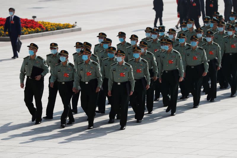 Military delegates arrive to the Great Hall of the People before the opening session of NPC in Beijing