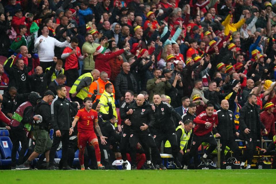 JOY: Rob Page in the thick of the celebrations when Wales secured qualification to the World Cup