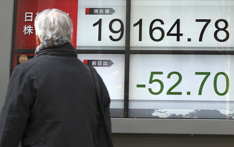 A man looks at an electronic stock board showing Japan's Nikkei 225 index at a securities firm in Tokyo, Thursday, March 30, 2017. Asian stocks are drifting lower on Thursday after a lackluster performance on Wall Street. (AP Photo/Eugene Hoshiko)