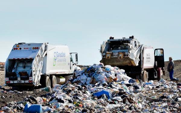 Trucks dump waste into Greenville County's Twin Chimneys Landfill on Dec. 17.