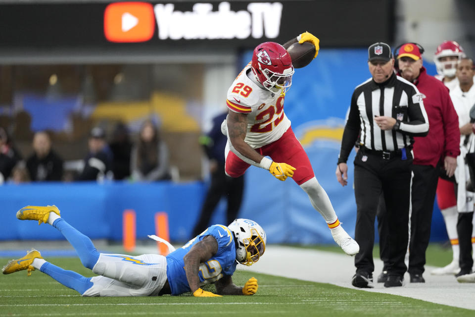Kansas City Chiefs running back La'Mical Perine, gets past Los Angeles Chargers cornerback Asante Samuel Jr., below, during the second half of an NFL football game, Sunday, Jan. 7, 2024, in Inglewood, Calif. (AP Photo/Ashley Landis)