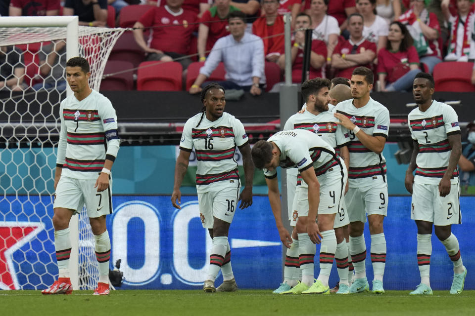 Portugal's Cristiano Ronaldo, left, celebrates after scoring his side's second goal during the Euro 2020 soccer championship group F match between Hungary and Portugal at the Ferenc Puskas stadium in Budapest, Hungary Tuesday, June 15, 2021. (AP Photo/Darko Bandic, Pool)