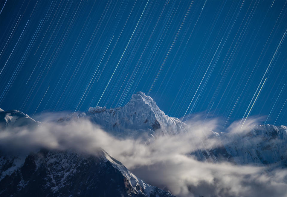 streaking stars above clouds