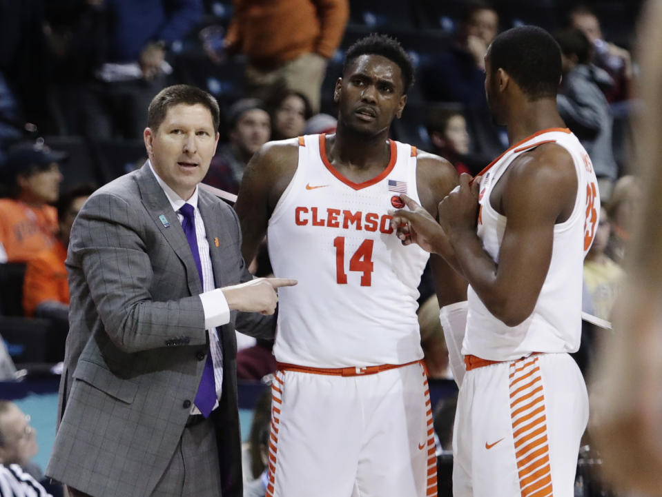 Clemson head coach Brad Brownell, left, talks to Elijah Thomas (14) and Aamir Simms (25). (AP Photo/Frank Franklin II)