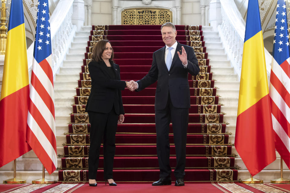 Romanian President Klaus Iohannis shakes hands with US Vice President Kamala Harris as she arrives for meetings at Cotroceni Palace in Otopeni, Romania, Friday, March 11, 2022. (Saul Loeb/Pool Photo via AP)