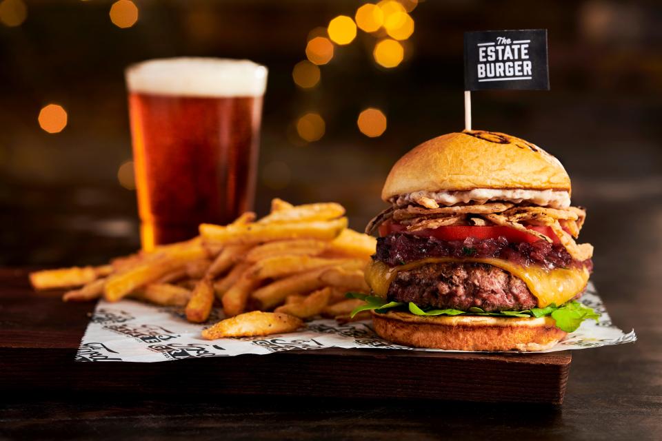 The Estate Burger, named in honor of Peyton Manning at Ford's Garage in Noblesville includes a third-pound Angus burger, smoked Gouda cheese, sweet red onion marmalade, arugula, tomato, crispy onion straws, and white truffle bacon aioli on a brioche bun.