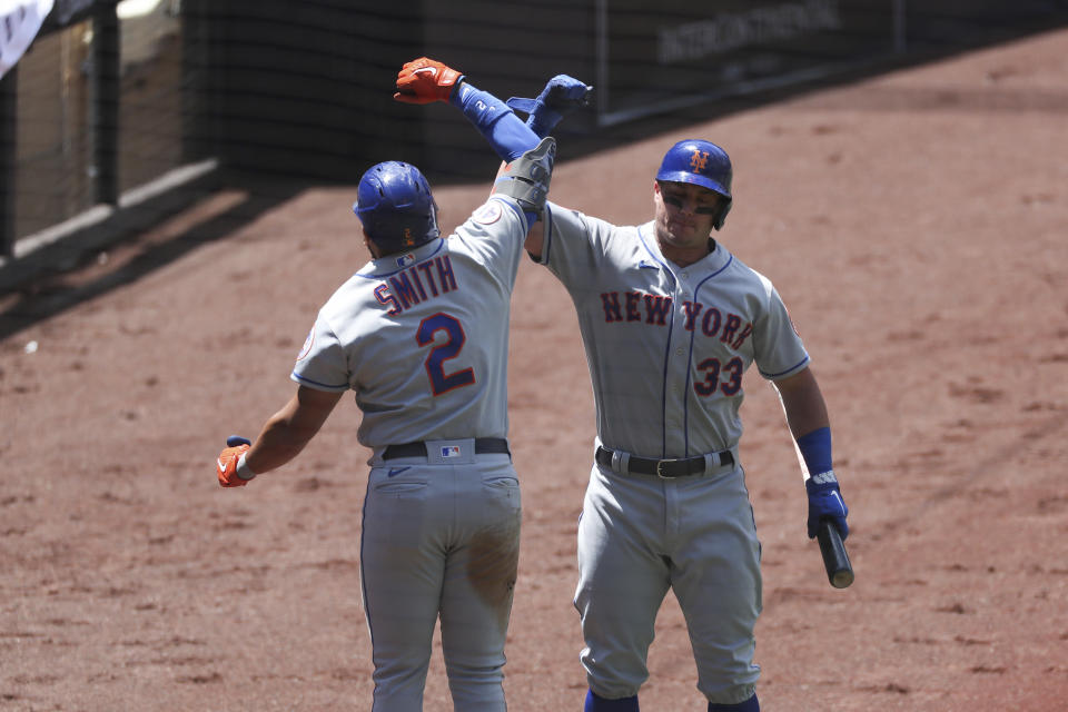 New York Mets' James McCann (33) celebrates with Dominic Smith (2) after as he goes back to the dugout after hitting a solo home run in the fourth inning of a baseball game against the San Diego Padres, Sunday, June 6, 2021, in San Diego. (AP Photo/Derrick Tuskan)