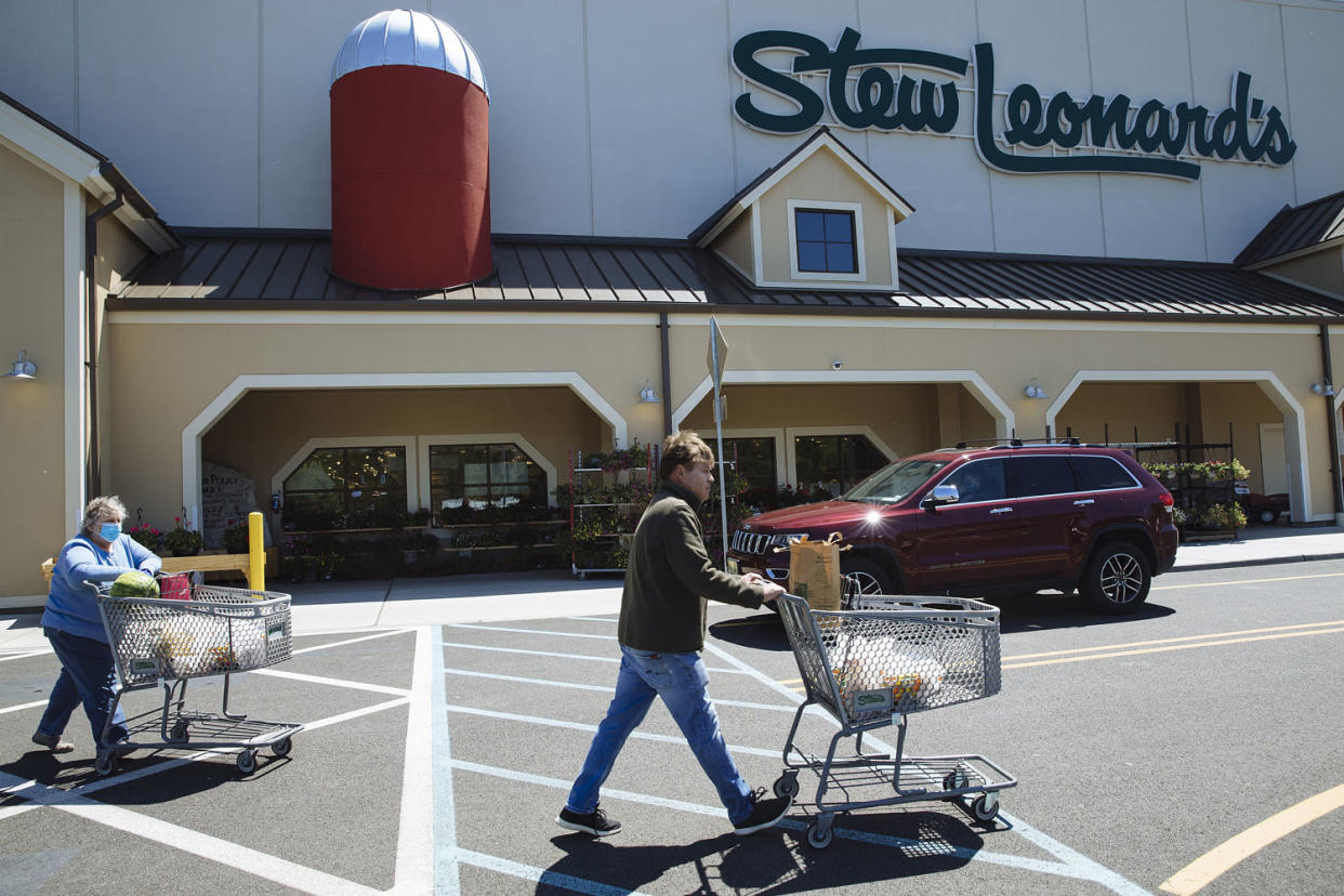 Customers push shopping carts outside a Stew Leonard's supermarket in New Jersey on May 12, 2020.  (Angus Mordant / Bloomberg via Getty Images file)
