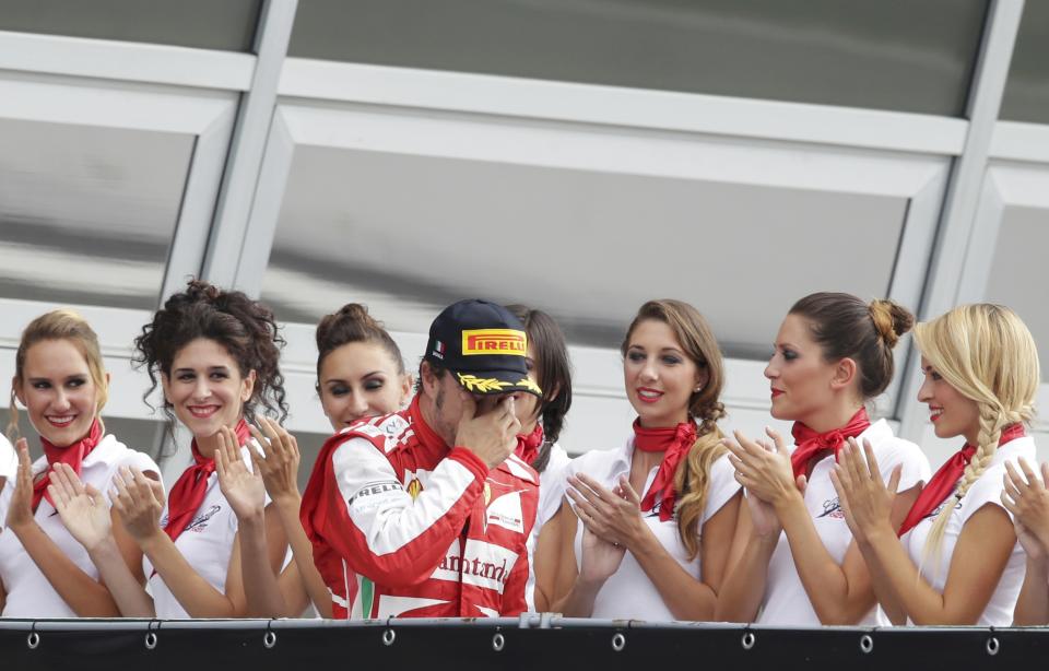 Ferrari Formula One driver Fernando Alonso of Spain arrives on the podium after placing second in the Italian F1 Grand Prix at the Monza circuit September 8, 2013. REUTERS/Max Rossi (ITALY - Tags: SPORT MOTORSPORT F1)