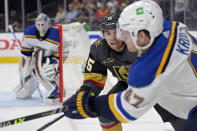 Vegas Golden Knights center Jake Leschyshyn (15) watches St. Louis Blues defenseman Torey Krug (47) during the second period of an NHL hockey game Wednesday, Oct. 20, 2021, in Las Vegas. (AP Photo/David Becker)