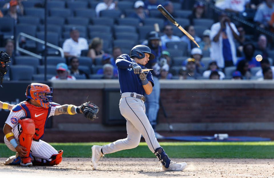 Seattle Mariners' Sam Haggerty, right, breaks his bat on a foul ball against the New York Mets during the ninth inning of a baseball game, Sunday, Sept. 3, 2023, in New York. (AP Photo/Noah K. Murray)