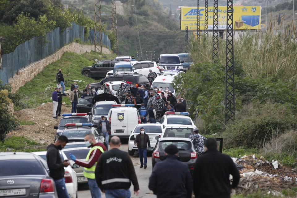 Lebanese security forces inspect the scene where Lokman Slim, a longtime Shiite political activist and researcher, was found shot dead in his car in Addoussieh village, southern province of Nabatiyeh, Lebanon, Thursday, Feb. 4, 2021. (AP Photo/Mohammed Zaatari)