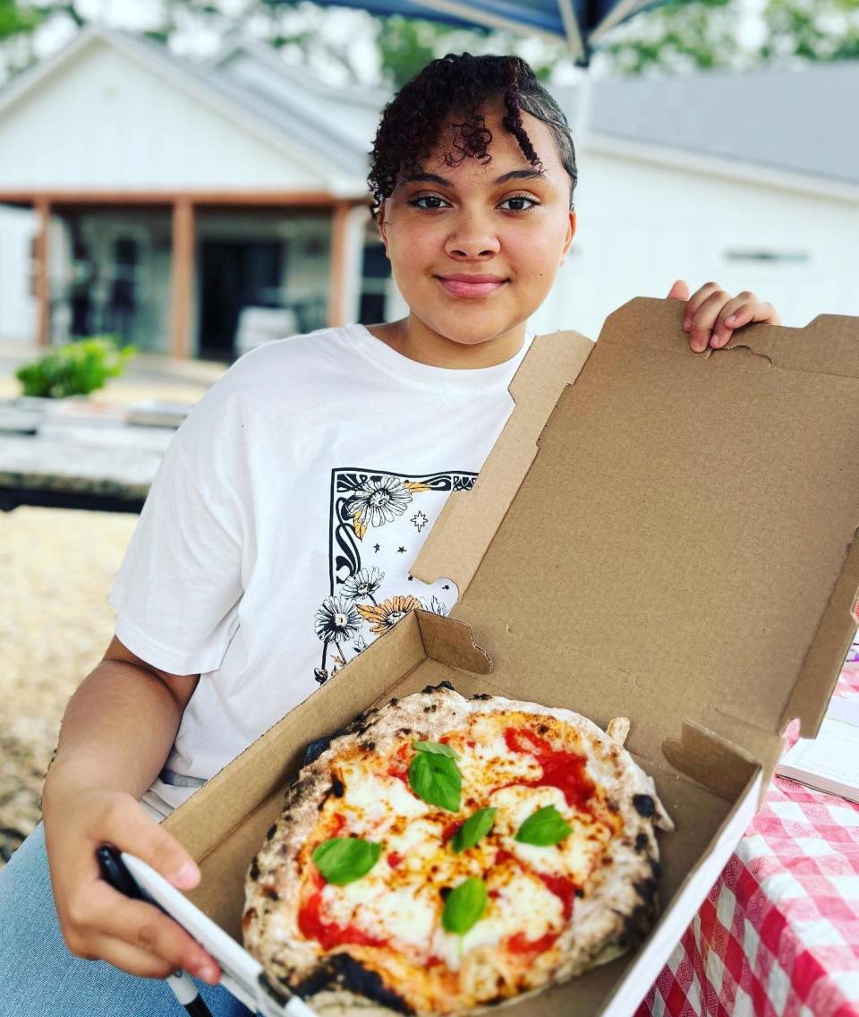 Makayla shows off a Furnace Pizza.