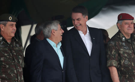 Brazil's President-elect Jair Bolsonaro talks with retired General Augusto Heleno during an event to celebrate the 73rd anniversary of Brazilian Paratrooper Infantry Brigade in Rio de Janeiro, Brazil November 24, 2018. Picture taken November 24, 2018. REUTERS/Ricardo Moraes