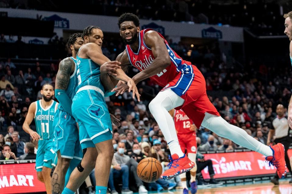 Philadelphia 76ers centre Joel Embiid (21) is fouled by Charlotte Hornets forward PJ Washington (AP Photo/Matt Kelley) (AP)