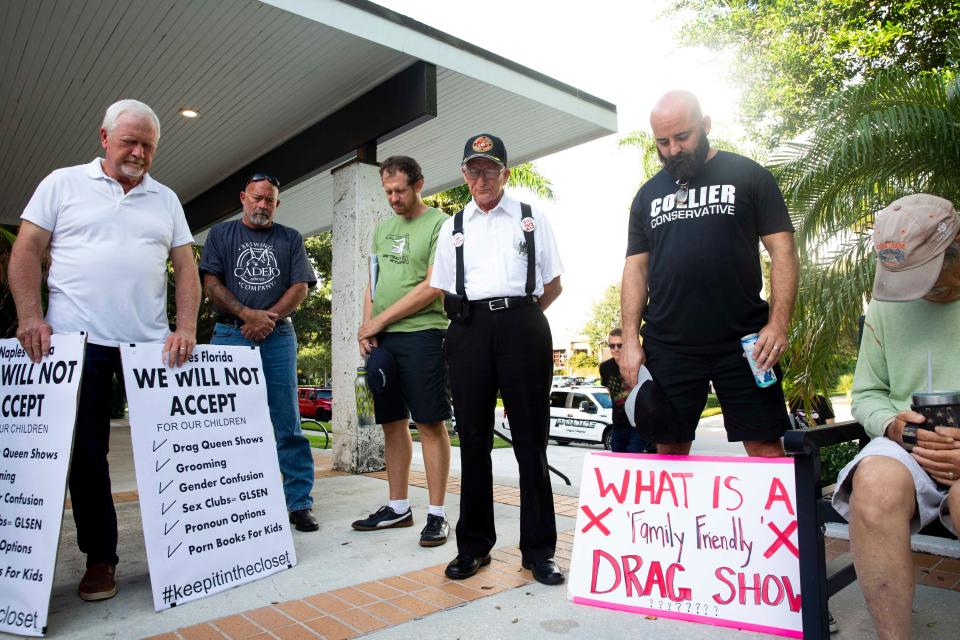 In this file photo, Jerry Rutherford of Naples, center, leads a group in prayer before a Naples City Council workshop session, Monday, Aug. 15, 2022, at Naples City Hall in Naples, Fla. Supporters and opposers of the drag show at the Naples Pride Festival in July spoke during public comments.