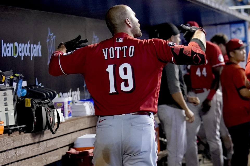 Cincinnati Reds' Joey Votto (19) reacts in the dugout after flying out during the ninth inning of a baseball game against the Miami Marlins, Sunday, Aug. 29, 2021, in Miami. The Marlins won 2-1. (AP Photo/Lynne Sladky)