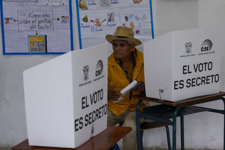 Un votante sostiene su boleta durante una segunda vuelta de las elecciones presidenciales en Olón, Ecuador