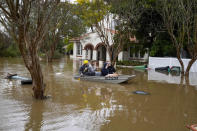 People paddle through a flooded street at Windsor on the outskirts of Sydney, Australia, Tuesday, July 5, 2022. Hundreds of homes have been inundated in and around Australia’s largest city in a flood emergency that was impacting 50,000 people, officials said Tuesday.(AP Photo/Mark Baker)