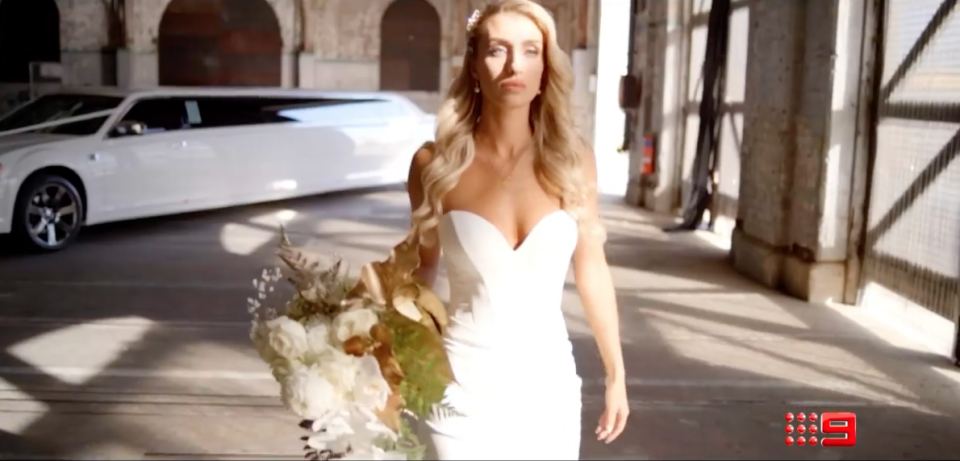 2022  Married At First Sight bride holding wedding flowers walking away from limousine 