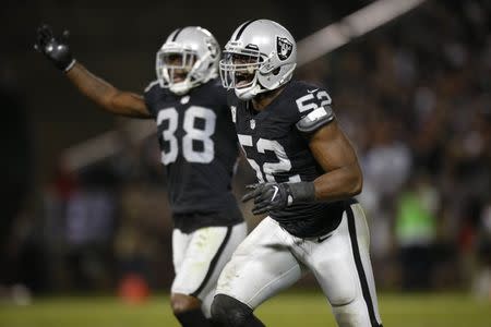 FILE PHOTO - Nov 6, 2016; Oakland, CA, USA; Oakland Raiders defensive end Khalil Mack (52) reacts after the Raiders recovered a fumble against the Denver Broncos in the fourth quarter at Oakland Coliseum. The Raiders defeated the Broncos 30-20. Mandatory Credit: Cary Edmondson-USA TODAY Sports