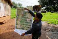 Community leader Cornelia Flores holds a map showing the community's territory which is being monitored with a smartphone app and GPS to protect lands and preserve forests, in Isla Jovai Teju, Paraguay May 9, 2019. REUTERS/Jorge Adorno