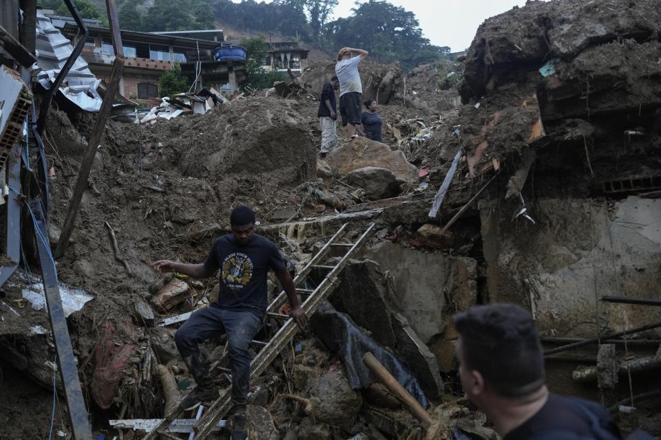 Residents look for victims in an area affected by deadly landslides in Petropolis, Brazil, on Feb. 16, 2022. (AP Photo/Silvia Izquierdo)