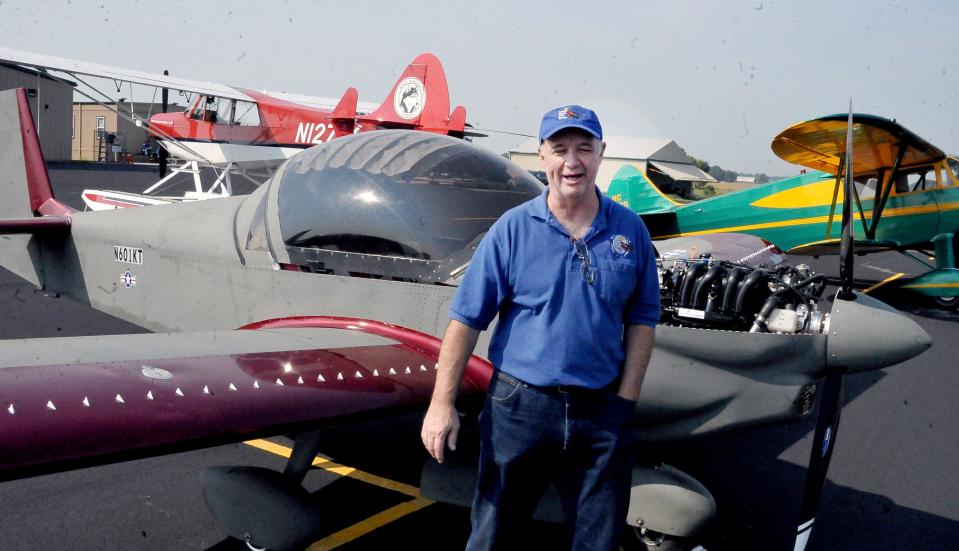 Karl Johnson and friends spent two years building the red and green 601 XL-B airplane he's standing in front of from a kit.