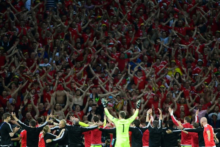 Wales' players celebrate with supporters after their team's 3-1 win in a Euro 2016 quarter-final football match against Belgium in Villeneuve-d'Ascq near Lille, on July 1, 2016