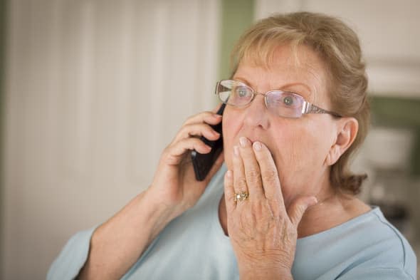 shocked senior adult woman on...