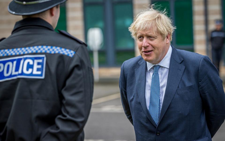 Boris Johnson with police - Charlotte Graham/Pool via REUTERS