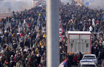 Protesters stand on the highway during a protest in Belgrade, Serbia, Saturday, Dec. 4, 2021. Thousands of protesters have gathered in Belgrade and other Serbian towns and villages to block roads and bridges despite police warnings and an intimidation campaign launched by authorities against the participants. Thousands of protesters have gathered in Belgrade and other Serbian towns and villages to block roads and bridges despite police warnings and an intimidation campaign launched by authorities against the participants. (AP Photo/Darko Vojinovic)