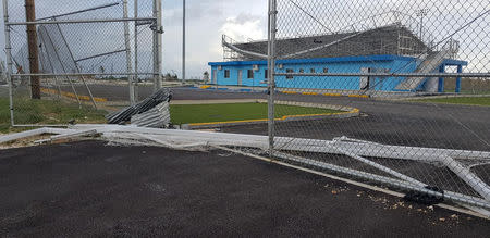 Damaged fencing and a partially collapsed bleacher is seen at a sports field after Super Typhoon Yutu hit Saipan, Northern Mariana Islands, U.S., October 25, 2018 in this image taken from social media. Brad Ruszala via REUTERS
