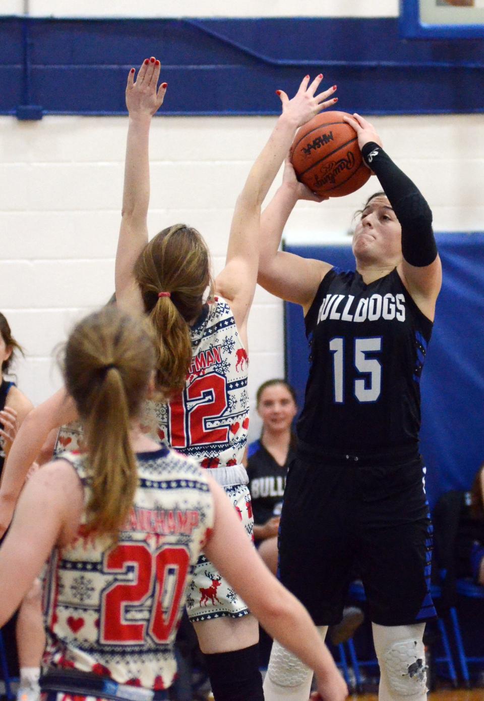 Inland Lakes' Natalie Wandrie tries to pull up for a shot with Mackinaw City's Larissa Huffman (12) defending.