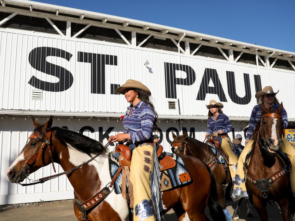 The St. Paul Rodeo court rides around the rodeo grounds before the grand entry.