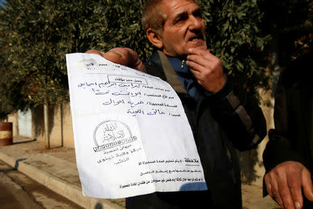 A man shows a paper to Iraqi security forces that Islamic State militants keeps his identity with them because he had shaved his beard, as Iraqi forces battle with Islamic State militants in Mosul, Iraq January 23, 2017. REUTERS/Ahmed Jadallah