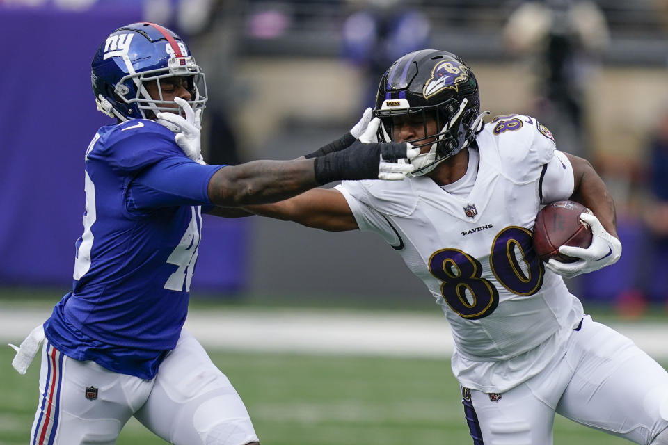 Baltimore Ravens' Isaiah Likely (80) stiff arms New York Giants' Tae Crowder (48) during the first half of an NFL football game, Sunday, Oct. 16, 2022, in East Rutherford, N.J. (AP Photo/Seth Wenig)