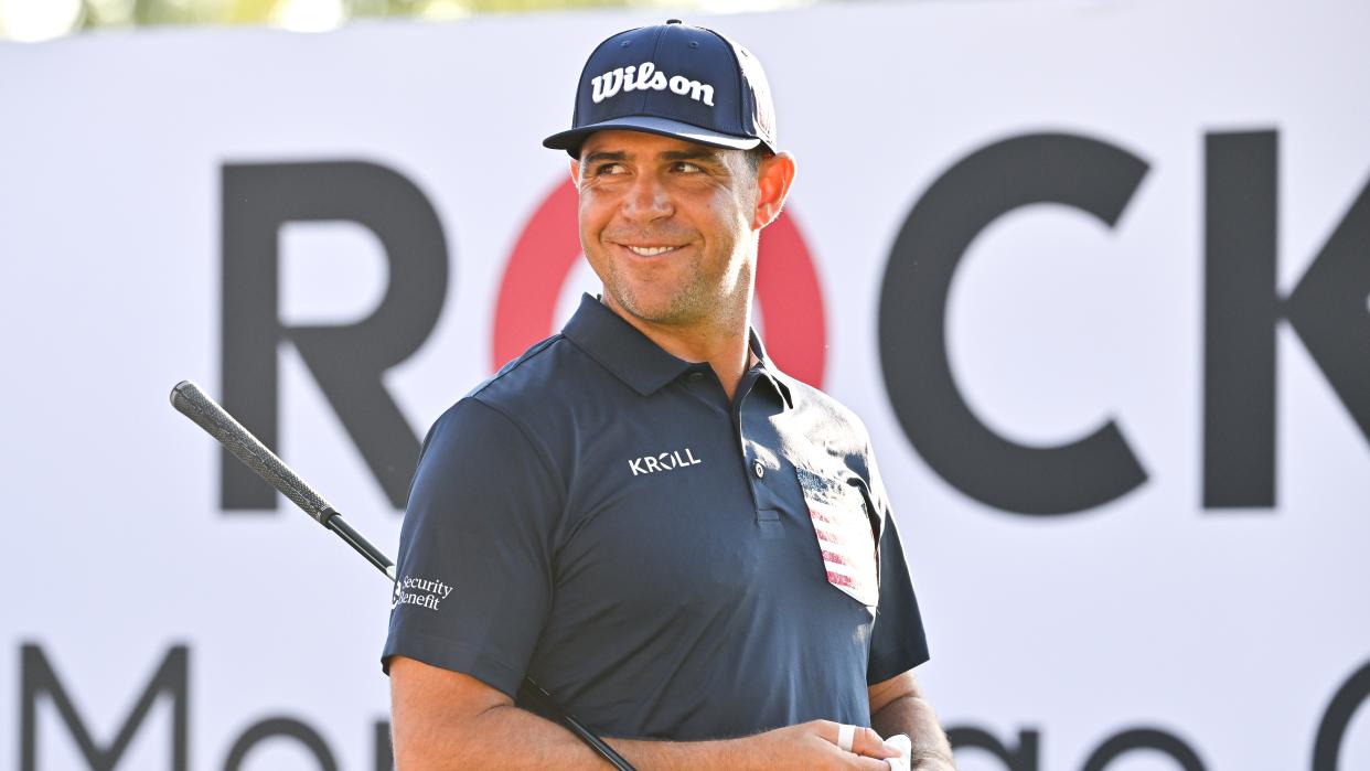  Gary Woodland smiles while stepping onto the 10th tee box during the first round of the Rocket Mortgage Classic at Detroit Golf Club  