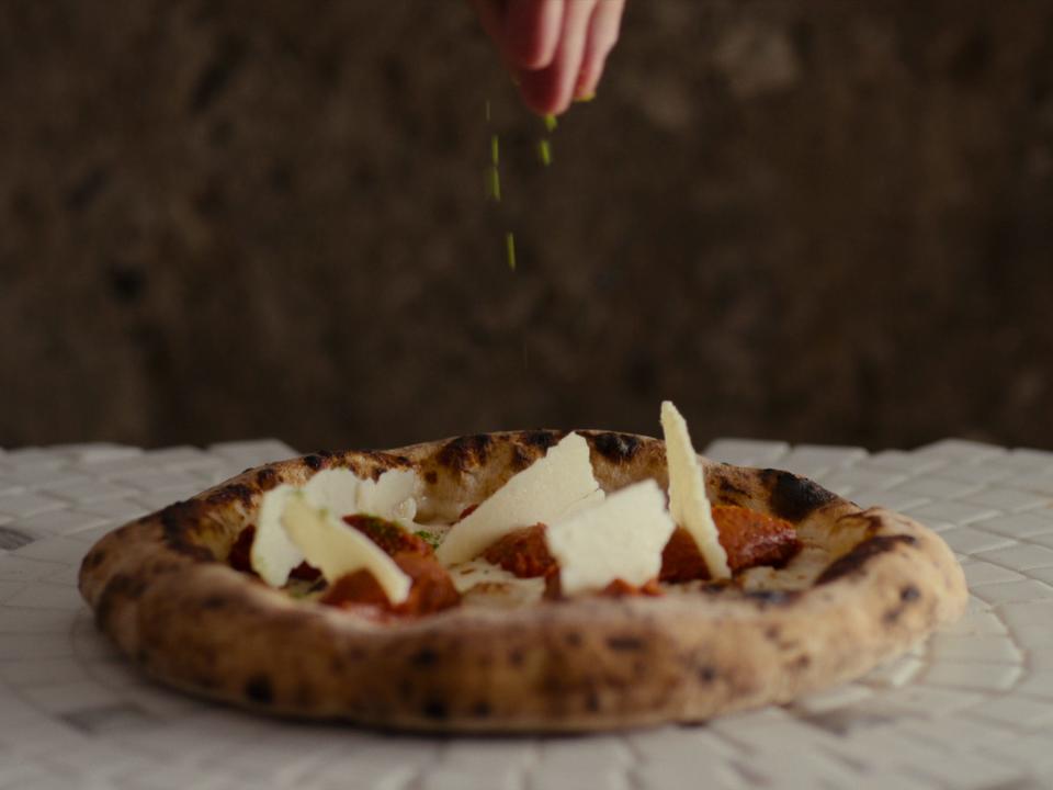 A pizza getting finishing touches on "Chef's Table: Pizza."