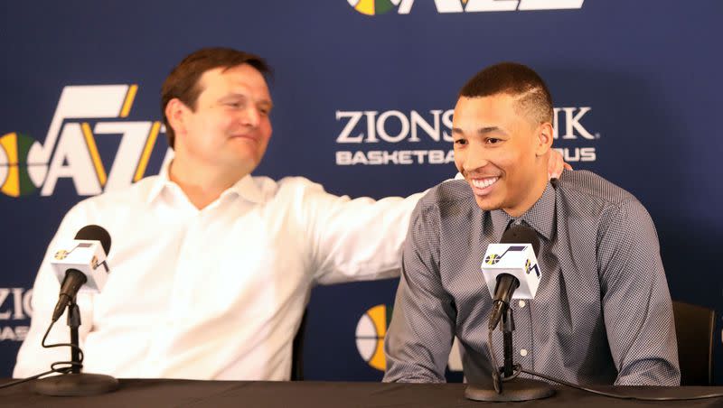 Utah Jazz general manager Dennis Lindsey squeezes Dante Exum during a press conference about Exum, Derrick Favors and Raul Neto re-signing with the Utah Jazz at the Zions Bank Basketball Center in Salt Lake City on Friday, July 6, 2018. Exum is reportedly back in the NBA with Lindsey and the Dallas Mavericks.
