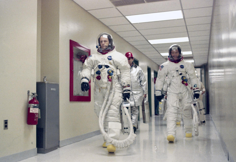 Apollo 11 Commander Neil Armstrong leading Michael Collins and Edwin "Buzz" Aldrin (hidden behind Collins) down a corridor on their way to participate in the launch countdown demonstration test on July 15, 1969.  (Photo: SSPL/Getty Images)