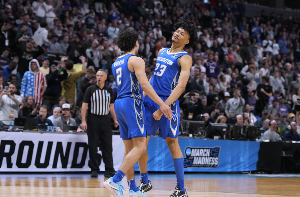 Creighton guard Ryan Nembhard, left, celebrates with guard Trey Alexander near the end of the team's second-round college basketball game against Baylor in the men's NCAA Tournament on Sunday, March 19, 2023, in Denver. (AP Photo/David Zalubowski)