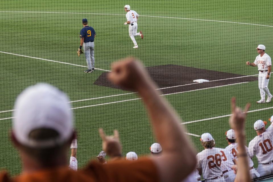 Fans cheer as Texas first baseman Jared Thomas rounds the bases after hitting a home run against West Virginia last Friday. The Longhorns trailed the Mountaineers by three games heading into the final series of the season and earned a share of the Big 12 title by sweeping them at UFCU Disch-Falk Field.