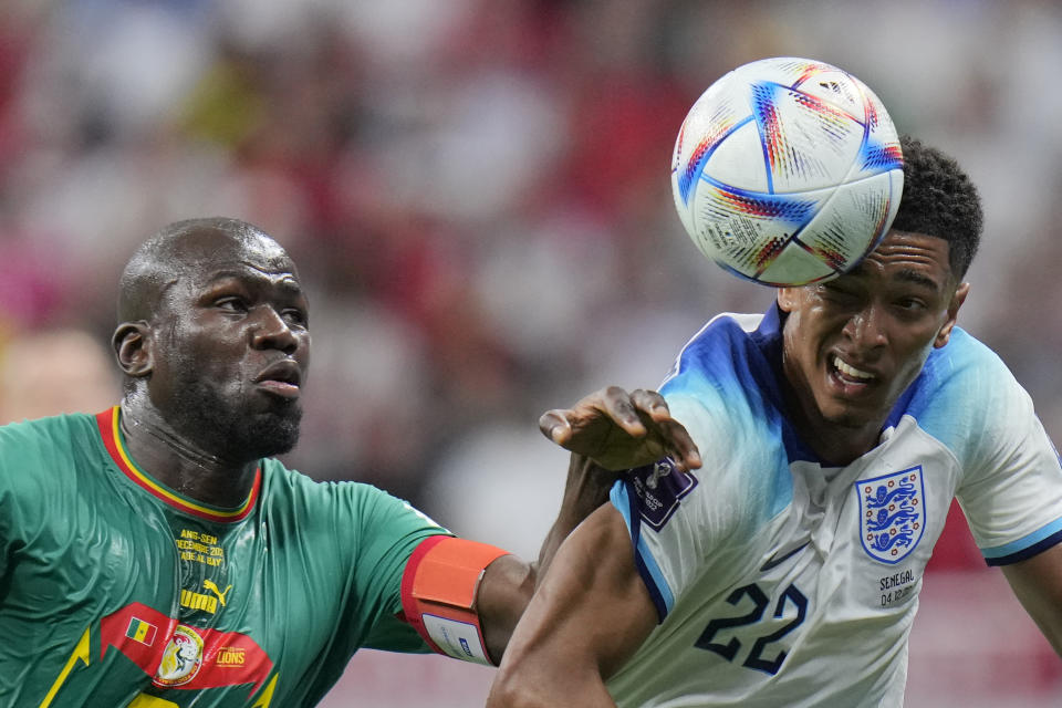 England's Jude Bellingham, right, challenges with Senegal's Kalidou Koulibaly during the World Cup round of 16 soccer match between England and Senegal, at the Al Bayt Stadium in Al Khor, Qatar, Sunday, Dec. 4, 2022. (AP Photo/Hassan Ammar)